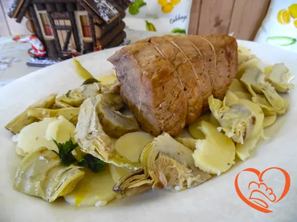 Arrosto di maiale con patate e carciofi
